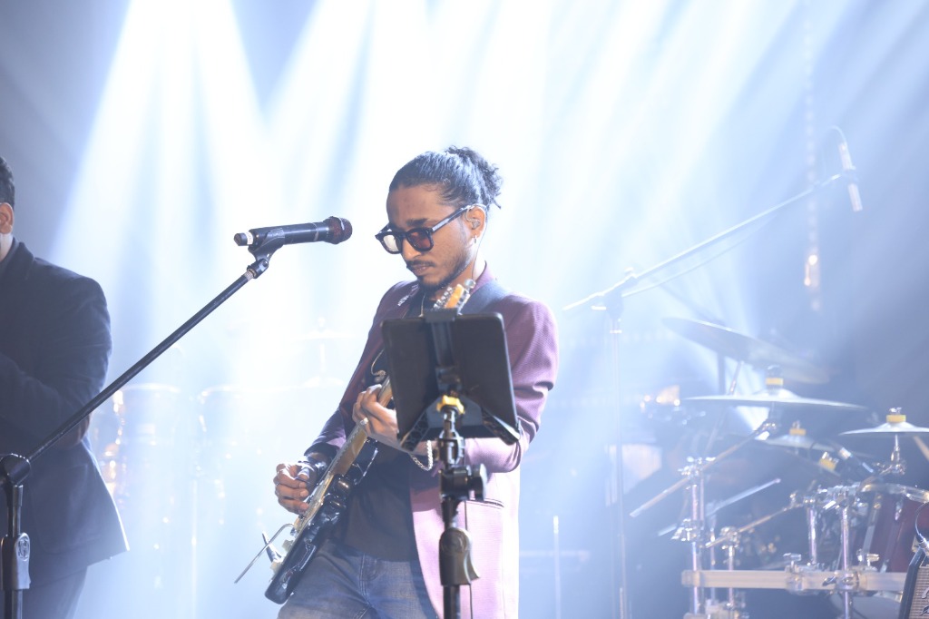 Close-up Guitarist Live Concert Performance under Spotlight